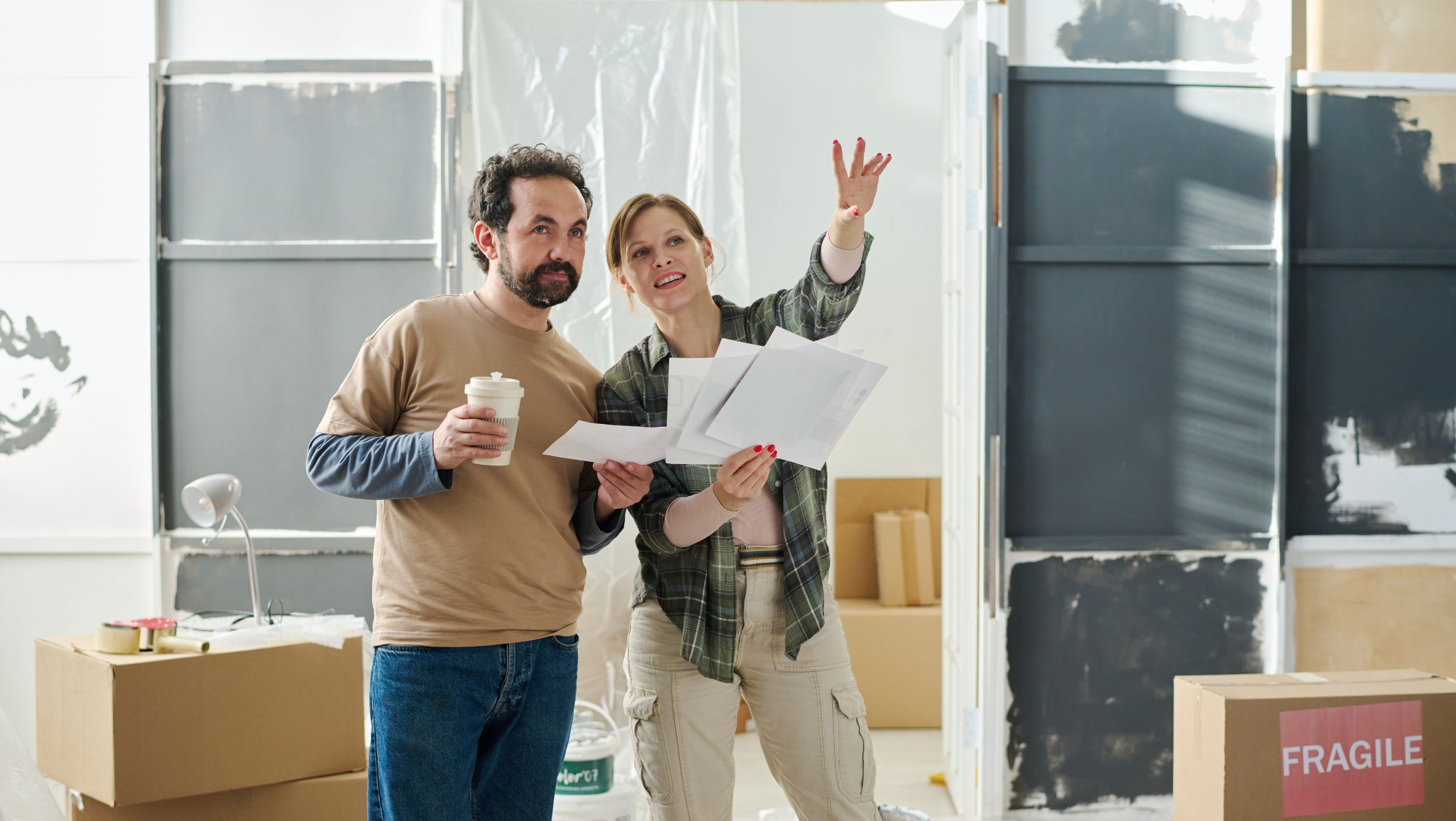 a couple depicted gazing into their home renovation project